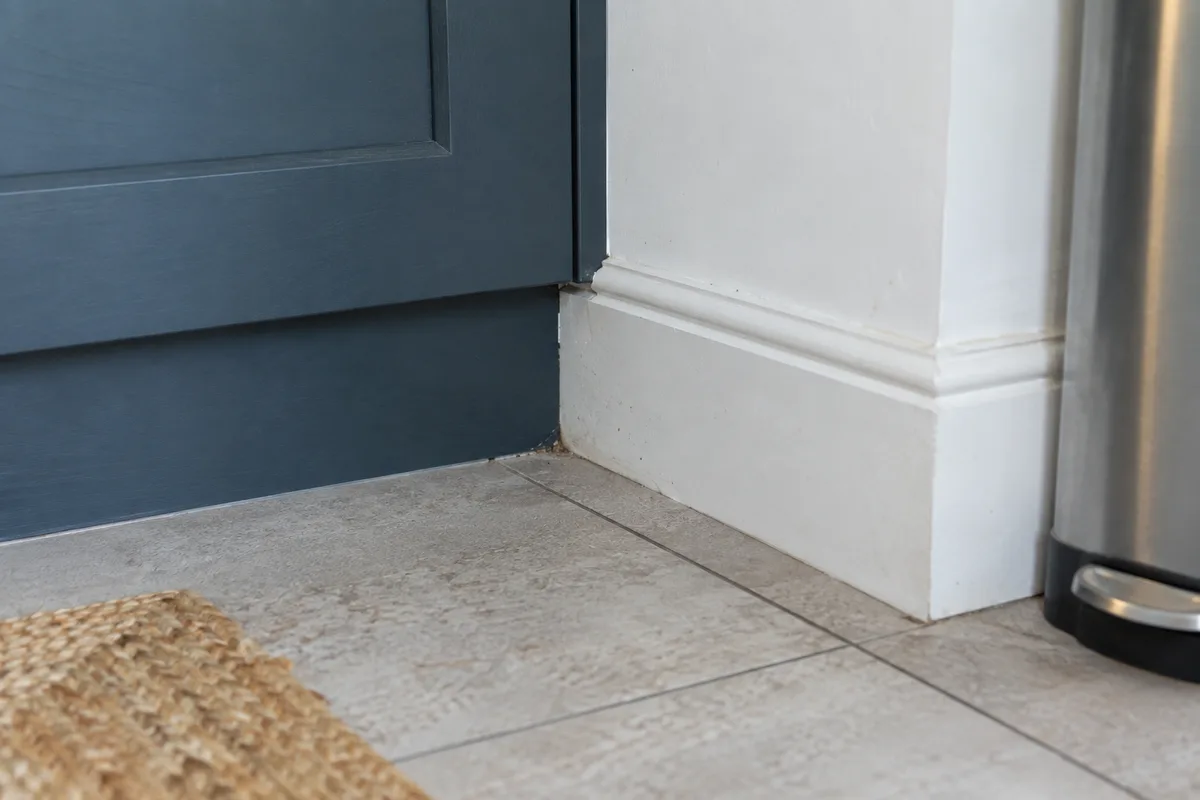 Floor junction beside a fitted cupboard